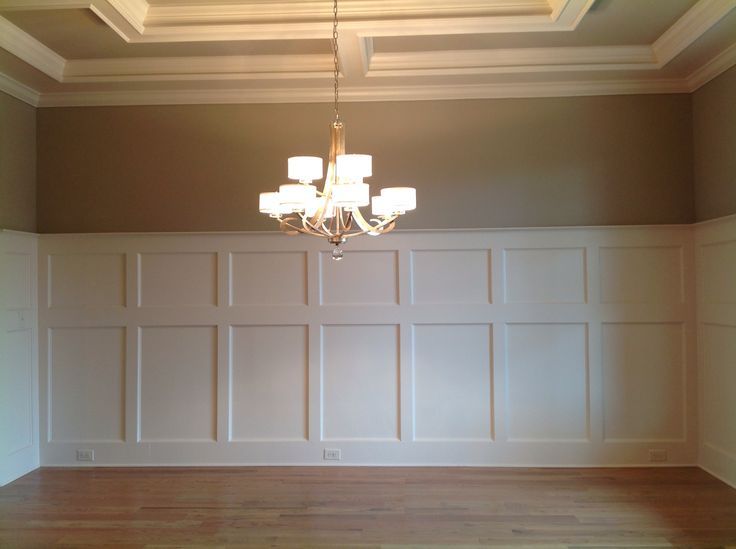 Tray ceiling with crown molding; wall with wain-cot panel, and red oak hardwood flooring.