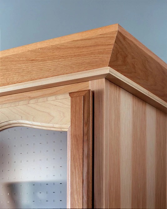 Two-piece crown molding on the cabinet. stained