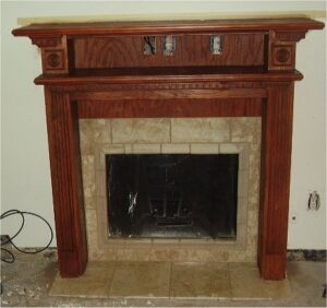 Fireplace trim with crown molding and fluted casing.
